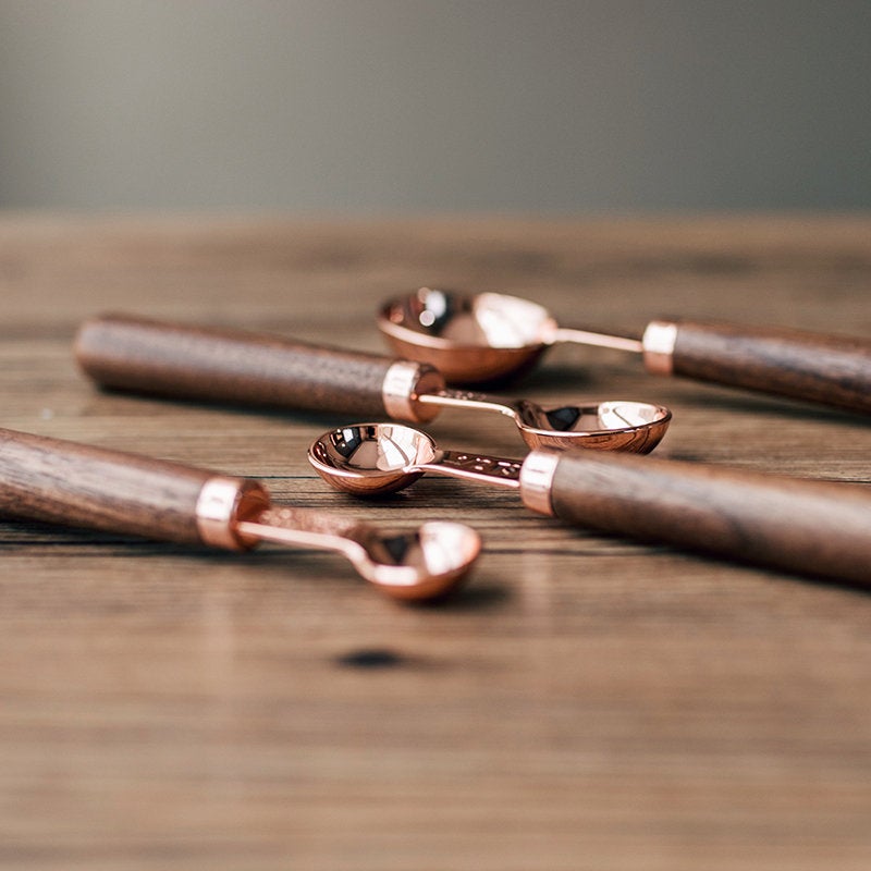 Set of Four Copper Measuring Spoons with Wooden Handles